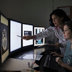 Imaging specialist reviewing CT images